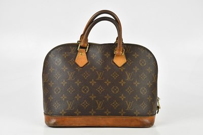Lot 703 - LOUIS VUITTON; a brown monogram 'Alma' coated...