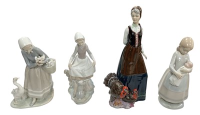 Lot 552 - LLADRÓ; three porcelain figures of ladies...