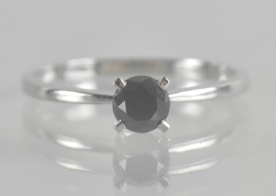 Lot 1336 - A 9ct white gold ring set with a small claw...