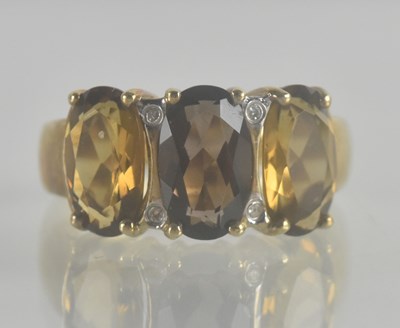 Lot 1280 - A 9ct gold dress ring, with a central smoky...