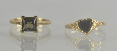 Lot 1288 - Two 9ct gold dress rings, one with a black...