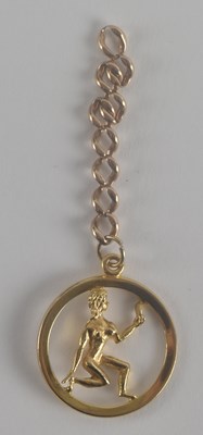 Lot 1412 - A 9ct gold circular pendant with a figure of a...