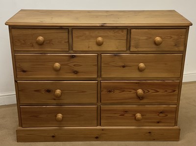 Lot 707 - A pine chest of three small over six larger...