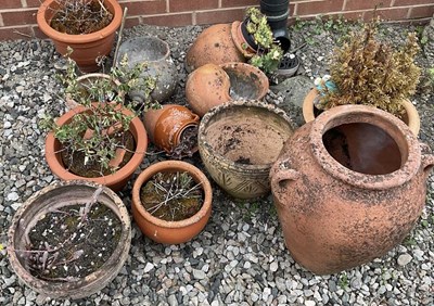 Lot 672 - A quantity of terracotta pots, including urns,...