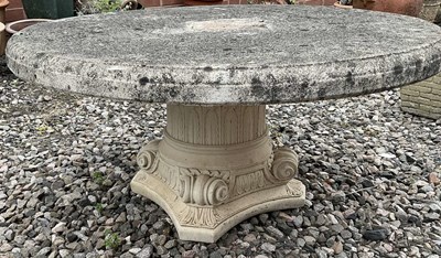 Lot 670 - A composite stone garden table, 50 x diameter...