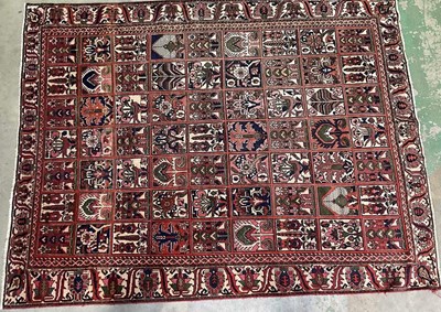 Lot 663 - A Bakhtiari hand woven woollen rug, decorated...