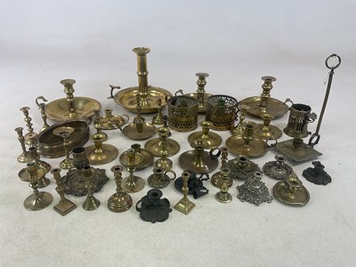 Lot 239 - A group of brass chambersticks, also smaller...