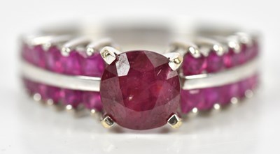 Lot 362 - A white metal claw set multi ruby dress ring,...