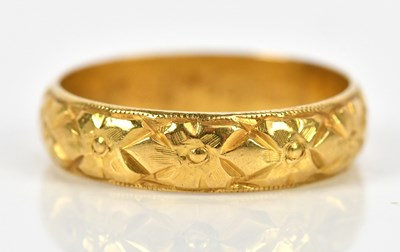 Lot 398 - A 22ct textured yellow gold wedding band, size...