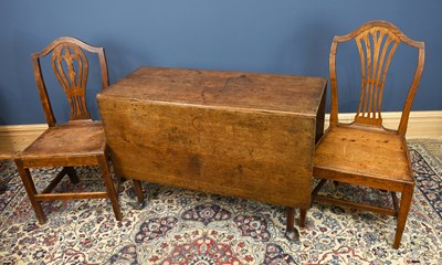 Lot 2980 - A George III oak drop-leaf dining table, on...