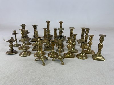 Lot 199 - A collection of brass candlesticks including...