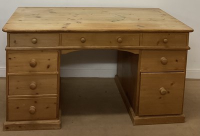 Lot 694 - A pine desk, with an arrangement of eight...