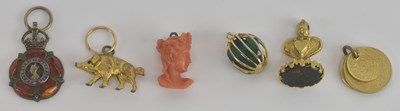 Lot 1194 - Six assorted yellow metal and other charms,...