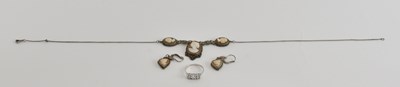 Lot 1552 - A white gold ring set with three white stones,...