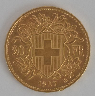 Lot 1613 - A Swiss twenty franc gold coin, 1927, with...
