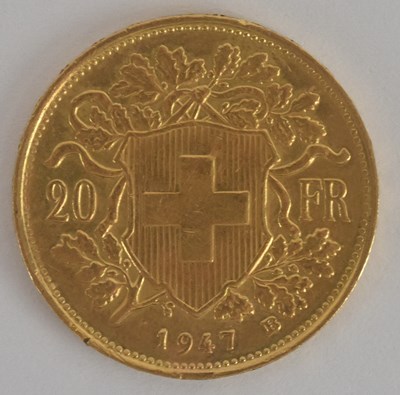 Lot 1614 - A Swiss twenty franc gold coin, 1947, with...