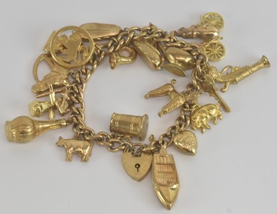 Lot 1493 - A 9ct yellow gold charm bracelet, with...