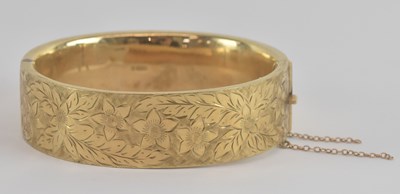 Lot 1505 - A 9ct yellow gold snap bangle, with engraved...