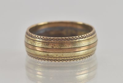 Lot 1355 - A 9ct gold band ring with beaded outer border,...