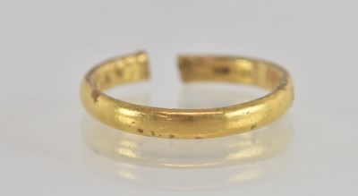 Lot 1290 - A thin gold band ring with cut shank, size N...