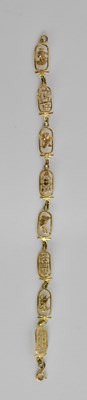 Lot 1510 - An 18ct gold Egyptian themed bracelet with...