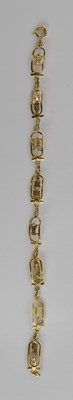 Lot 1502 - An 18ct gold Egyptian themed bracelet with...