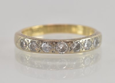 Lot 1277 - An 18ct gold half eternity ring set with seven...