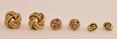 Lot 1448 - Three pairs of 9ct gold earrings, all of knot...