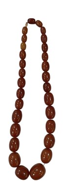 Lot 1436 - An amber style necklace with graduated beads,...