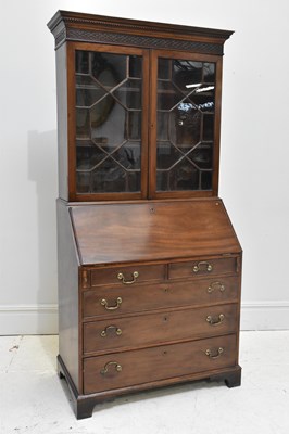 Lot 1074 - A Georgian mahogany bureau bookcase, the upper...