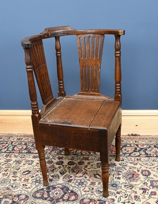 Lot 2981 - A George III provincial oak corner chair with...