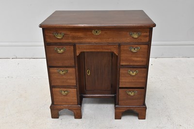 Lot 1076 - A Georgian mahogany kneehole desk of small...