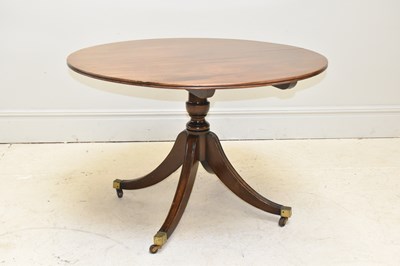 Lot 1044 - A reproduction circular breakfast table on...