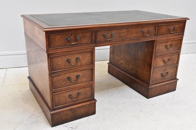 Lot 1100 - A large reproduction pedestal desk with green...