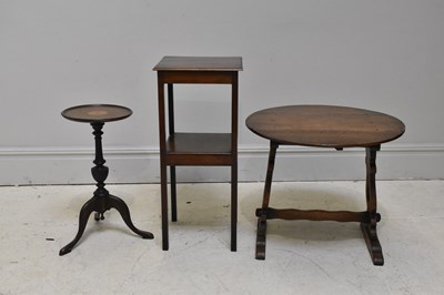 Lot 1142 - A small reproduction oak oval drop-leaf table,...