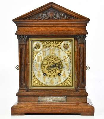 Lot 1282 - An oak cased mantel clock, with brass dial set...