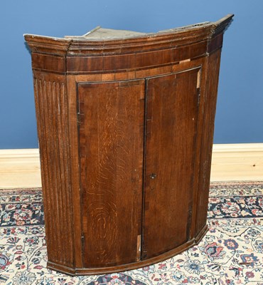 Lot 2837 - A George III mahogany bowfront hanging corner...