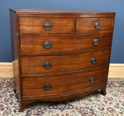 Lot 2763 - A George III mahogany bowfront chest of two...