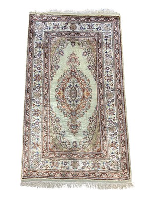 Lot 1258 - A Persian hand woven part silk mat, worked...