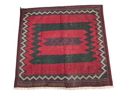 Lot 1256 - A red ground Persian hand knotted rug, with...