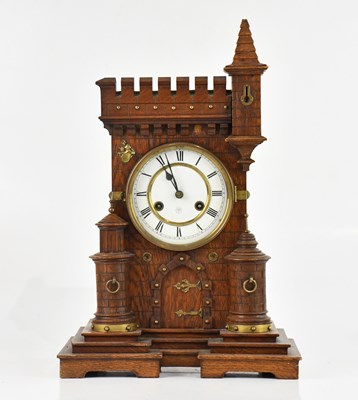 Lot 266 - An early 20th century oak mantel clock formed...