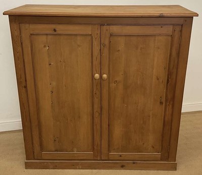 Lot 701 - A two door reclaimed pine cupboard fitted with...