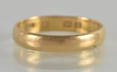 Lot 1345 - A hallmarked yellow gold band ring, size M,...