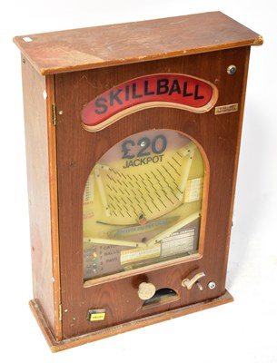 Lot 530 - A wooden cased, wall-mounted slot machine...