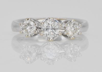 Lot 580 - An 18ct white gold three stone graduated...