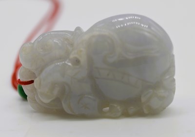 Lot 16 - A Chinese mutton fat jade carving, depicting a...