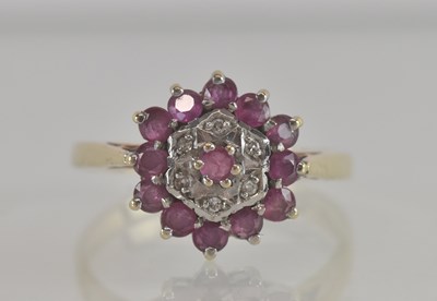 Lot 1317 - A 9ct gold diamond and ruby cluster ring, size...
