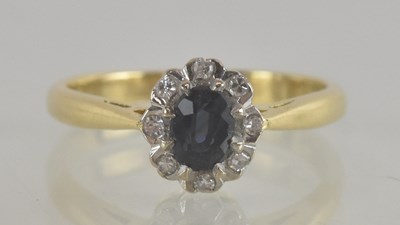 Lot 1350 - An 18ct gold ring with sapphire and tiny...