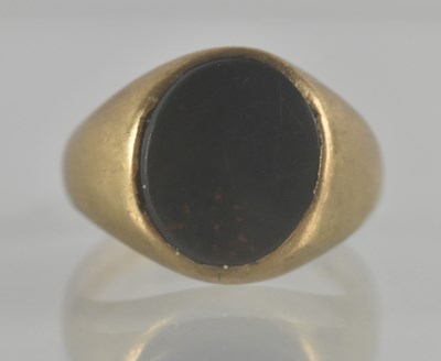 Lot 1351 - A 9ct gold signet ring with oval gold stone...