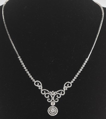 Lot 1363 - An 18ct white gold diamond set necklace, set...